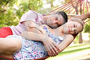 Couple Relaxing In Hammock