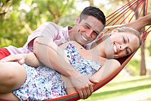 Couple Relaxing In Hammock