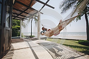 Couple relaxing in a hammock by the beach