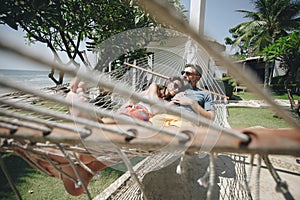 Couple relaxing in a hammock by the beach