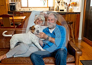 Couple relaxing at home and loving their pet. Positive image of life at home and New Normal