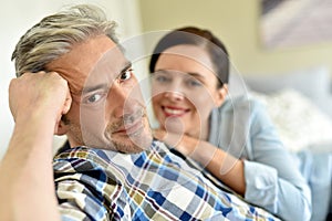 Couple relaxing at home with wife