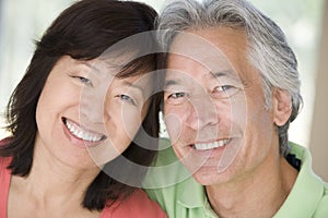 Couple relaxing indoors and smiling