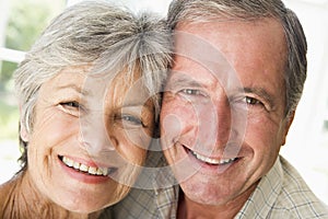 Couple relaxing indoors smiling