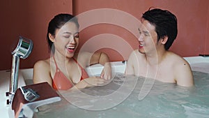 Couple relaxing inside bathtub