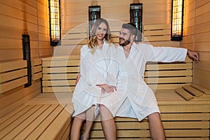 Couple relaxing inside spa sauna room