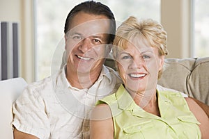 Couple relaxing in living room and smiling