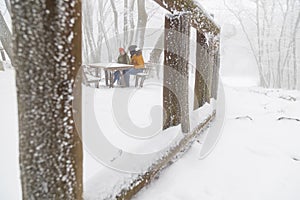 Couple relaxing outdoor on snowy winter day