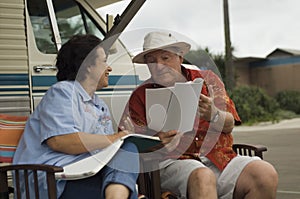 Couple Relaxing Outside Their Motor Home