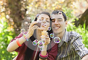 Couple Relaxing in the Park with bubble blower