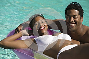 Couple Relaxing in Swimming Pool portrait.