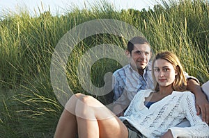 Couple relaxing In Tall Grass