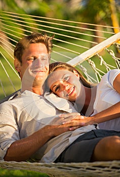 Couple relaxing in tropical hammock