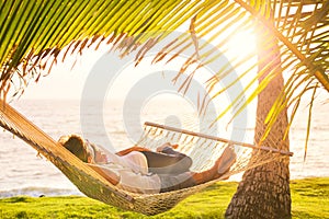 Couple relaxing in tropical hammock