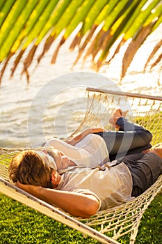 Couple relaxing in tropical hammock
