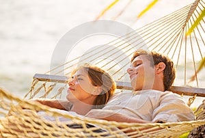 Couple relaxing in tropical hammock