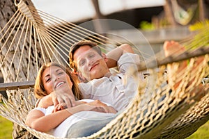 Couple relaxing in tropical hammock