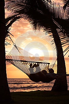 Couple relaxing in tropical hammock