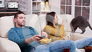 Couple relaxing watching a movie on tv