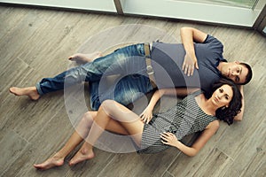 Couple relaxing on wooden floor