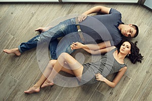 Couple relaxing on wooden floor