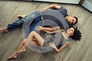 Couple relaxing on wooden floor