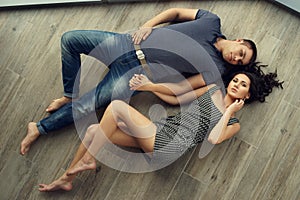 Couple relaxing on wooden floor