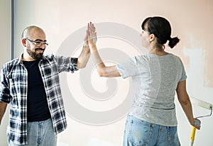 Couple renovating the house joining hands