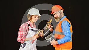 Couple renovating house. Woman builder hard hat. Man engineer or architect. Gender equality. Construction site. Quality