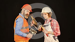 Couple renovating house. Woman builder hard hat. Man engineer or architect. Gender equality. Construction site. Quality