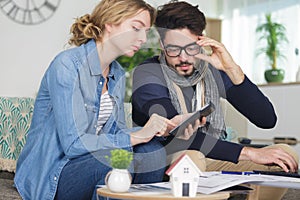 Couple researching housing possibilities on tablet