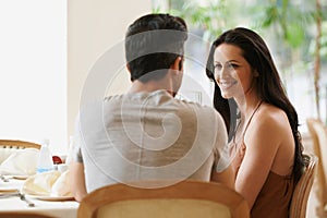 Couple, restaurant and conversation on date, love and bonding on valentines day. People, speaking and romance at cafe or