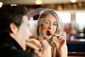 Couple in Restaurant eating fast food