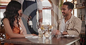 Couple, restaurant and waiter pour wine on date for anniversary meal, valentines day or engagement. Man, woman and