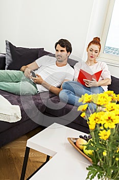 Couple Resting on the Sofa at the Living Room