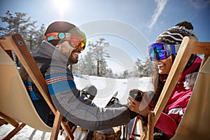 Couple resting in sunbed and drinking tea