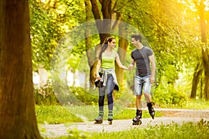 Couple ride rollerblades