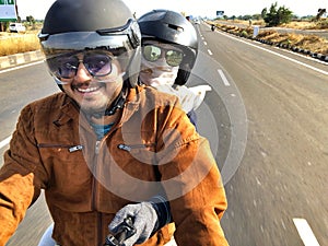 Couple riding a bike for their expedition in India