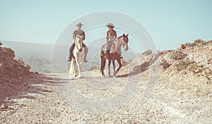 Couple riding horses in countryside nature tour - Happy people having fun on summer day - Vacation, excursion, healthy lifestyle,