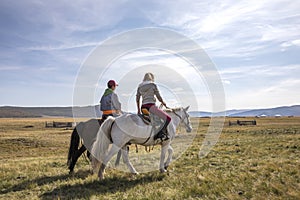 Coupleriding mongolian horses photo
