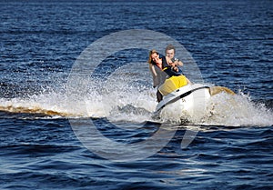 Couple riding jet ski