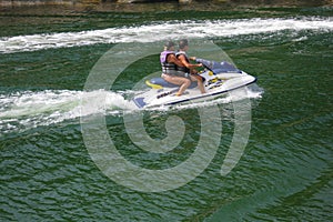 Couple riding a personal watercraft