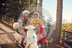 Couple riding a scooter and having fun on journey