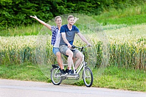 Couple riding tandem bike together in the country