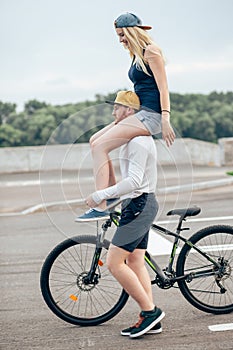 Couple riding their bikes in their free time and having fun on sunny autumn day.