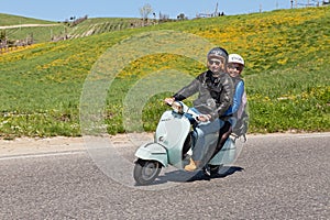 Couple riding a vintage scooter