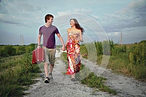 Couple on road with suitcase photo