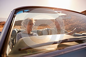 Couple on road trip, seen through car windscreen, close up