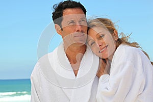 Couple in robes at the beach