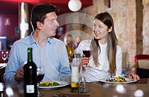 couple on romantic date drinking red wine